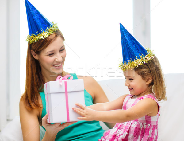 mother and daughter in blue hats with favor horns Stock photo © dolgachov