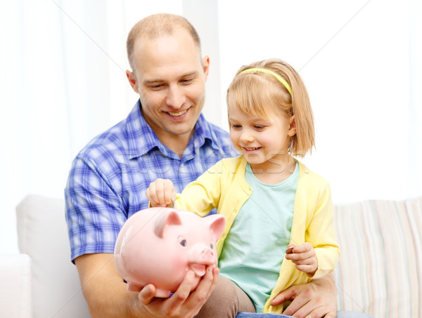 happy father and daughter with big piggy bank Stock photo © dolgachov