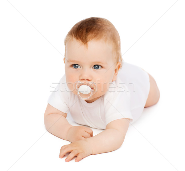 smiling baby lying on floor with dummy in mouth Stock photo © dolgachov