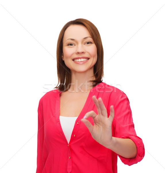 woman in casual clothes showing ok gesture Stock photo © dolgachov