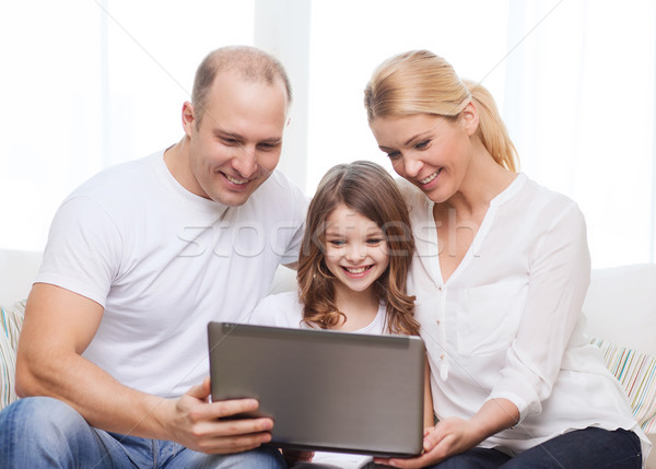 parents and little girl with laptop at home Stock photo © dolgachov