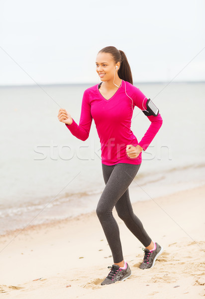 smiling woman running on track outdoors Stock photo © dolgachov