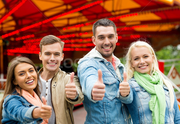 group of smiling friends showing thumbs up Stock photo © dolgachov