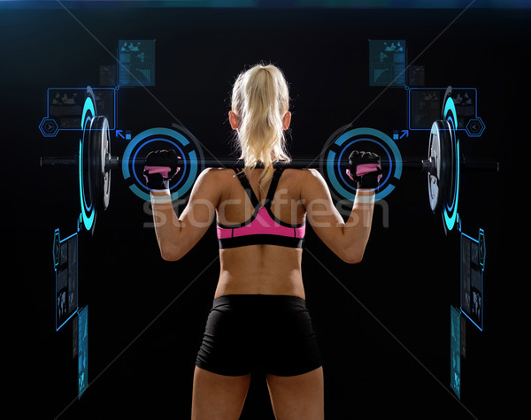 sporty woman exercising with barbell from back Stock photo © dolgachov
