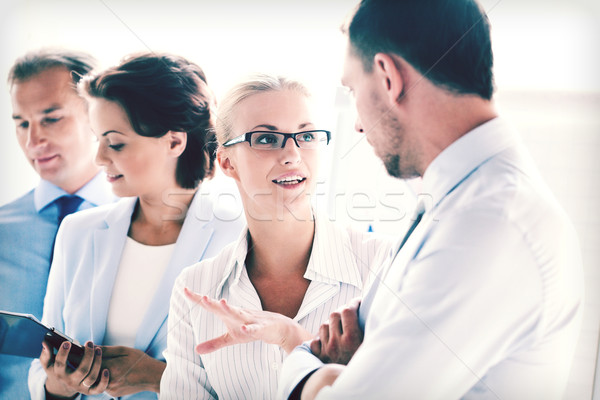 man and woman having discussion in office Stock photo © dolgachov