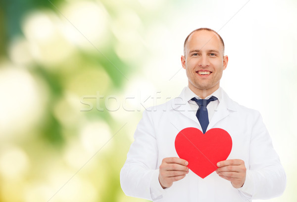 smiling male doctor with red heart Stock photo © dolgachov