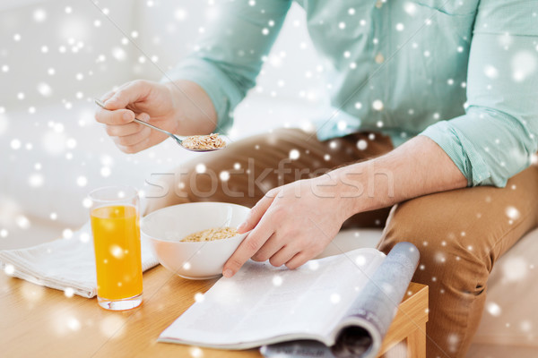 close up of man with magazine eating breakfast Stock photo © dolgachov