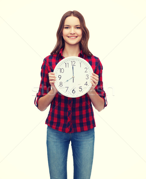young woman in casual clothes with wall clock Stock photo © dolgachov