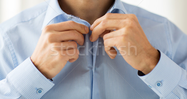 close up of man in shirt dressing  Stock photo © dolgachov