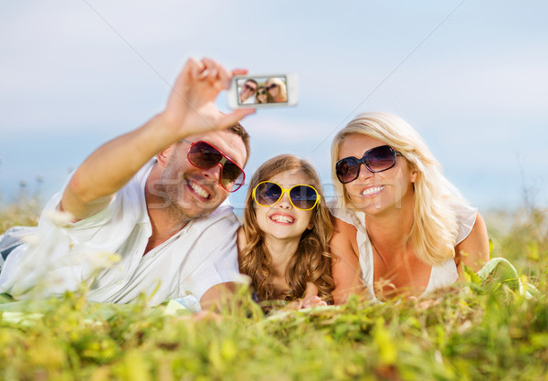 happy family with camera taking picture Stock photo © dolgachov