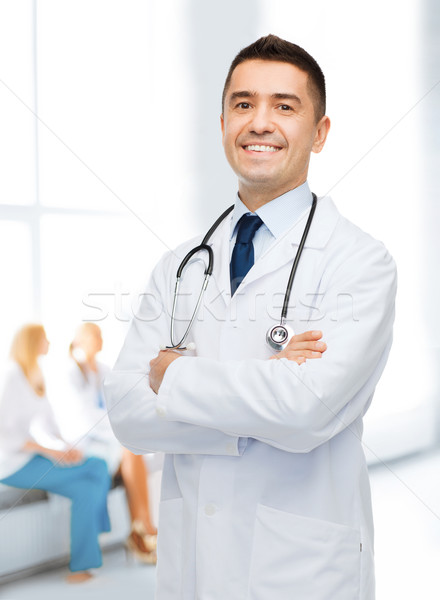 smiling male doctor in white coat at hospital Stock photo © dolgachov