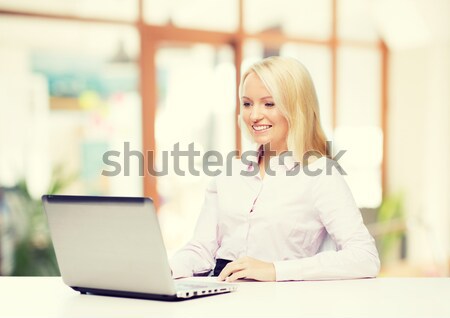 smiling businesswoman calling on smartphone Stock photo © dolgachov