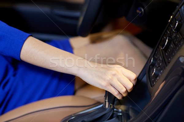 Stock photo: close up of woman shifting gears on gearbox in car