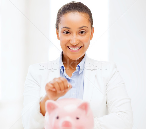 woman with piggy bank and coin Stock photo © dolgachov