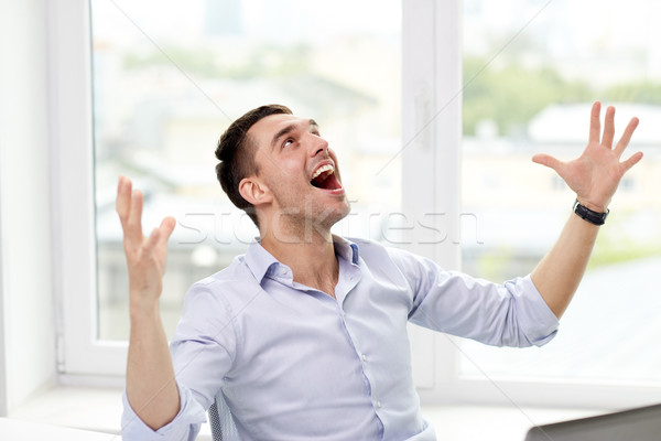 happy businessman with laptop in office Stock photo © dolgachov