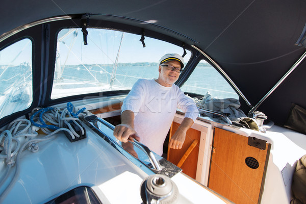 happy senior man on boat or yacht sailing in sea Stock photo © dolgachov