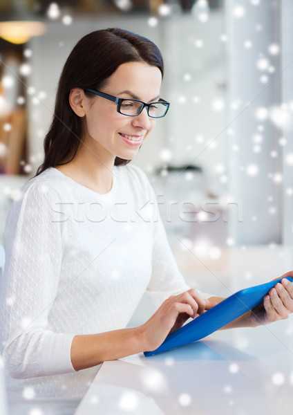smiling woman with tablet pc at cafe Stock photo © dolgachov