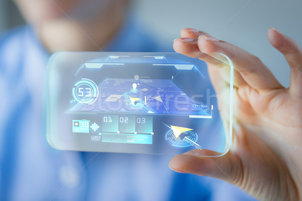 Stock photo: close up of woman with transparent smartphone