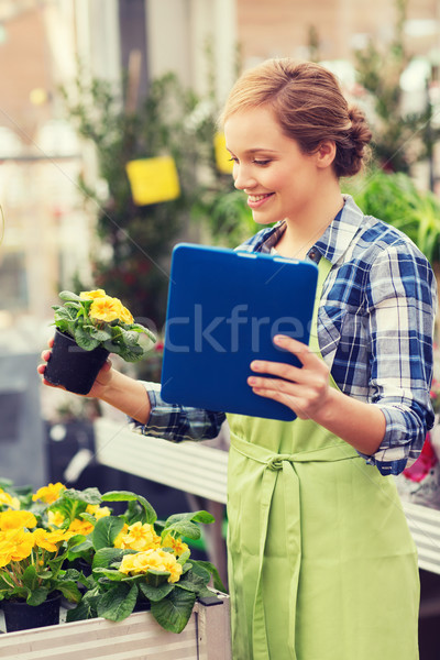 happy woman with tablet pc in greenhouse Stock photo © dolgachov