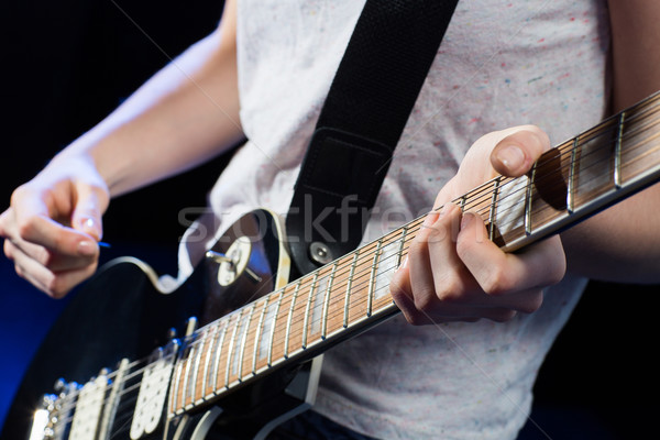 musician playing electric guitar with mediator Stock photo © dolgachov
