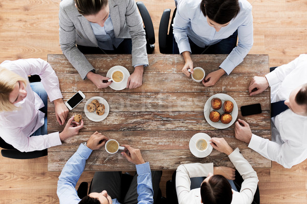 close up of business team drinking coffee on lunch Stock photo © dolgachov