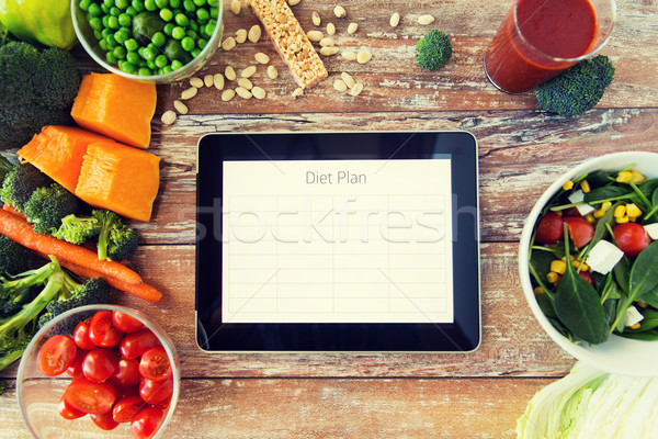 close up of diet plan on tablet pc and vegetables Stock photo © dolgachov