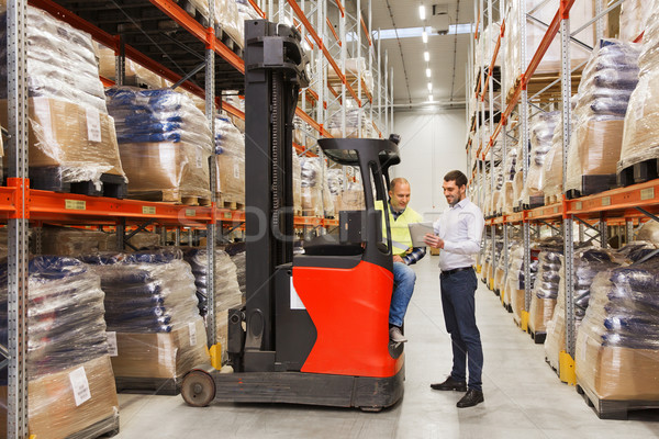 men with tablet pc and forklift at warehouse Stock photo © dolgachov