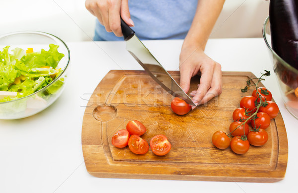 close up of woman chopping tomatoes with knife Stock photo © dolgachov