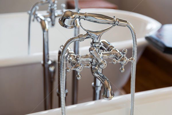 close up of bath tap and shower at bathroom Stock photo © dolgachov
