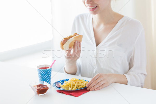 close up of woman eating hotdog and french fries Stock photo © dolgachov