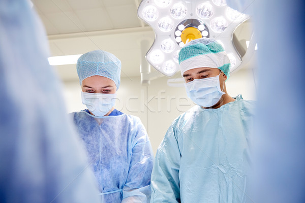 Stock photo: group of surgeons in operating room at hospital