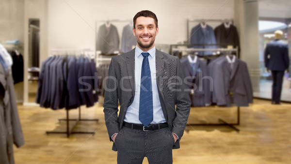 happy young businessman over clothing store Stock photo © dolgachov