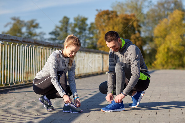 Mosolyog pár cipőfűző kint fitnessz sport Stock fotó © dolgachov