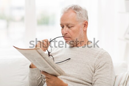 senior woman with glucometer checking blood sugar Stock photo © dolgachov