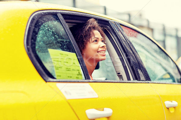 happy african american woman driving in taxi Stock photo © dolgachov