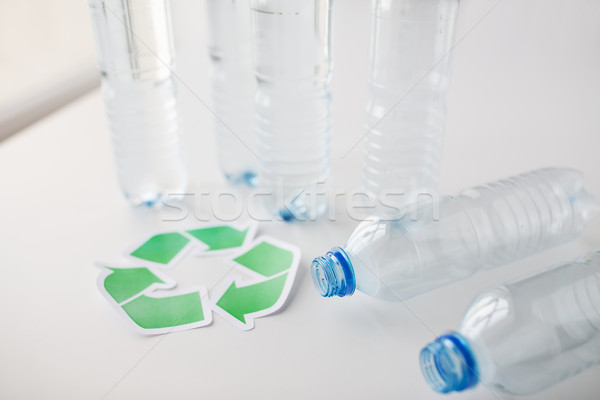 close up of plastic bottles and recycling symbol Stock photo © dolgachov