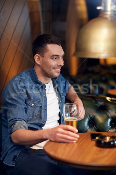 happy man drinking draft beer at bar or pub Stock photo © dolgachov