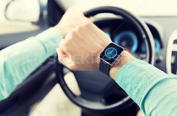 close up of male hands with wristwatch driving car Stock photo © dolgachov