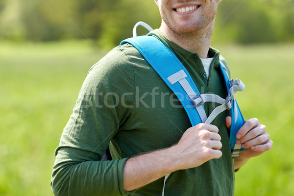 close up of happy young man with backpack hiking Stock photo © dolgachov