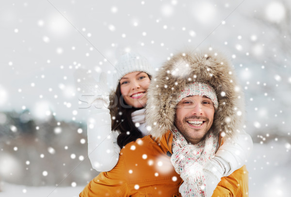 Stock photo: happy couple having fun over winter background