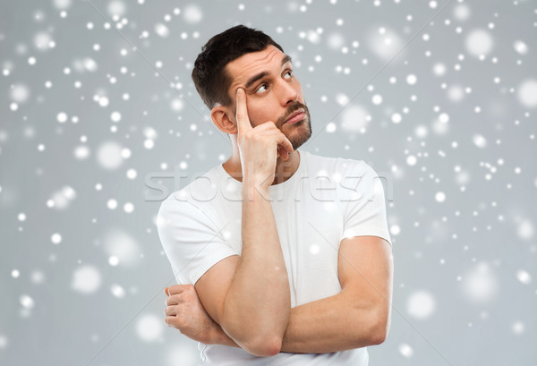 Stock photo: man thinking over snow on gray background