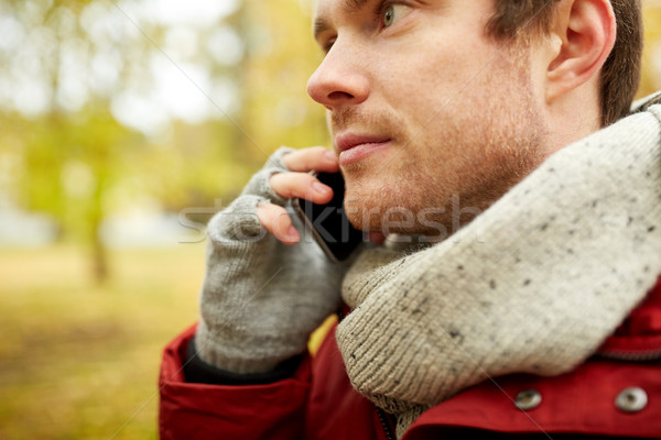 close up of man with smartphone calling in autumn Stock photo © dolgachov