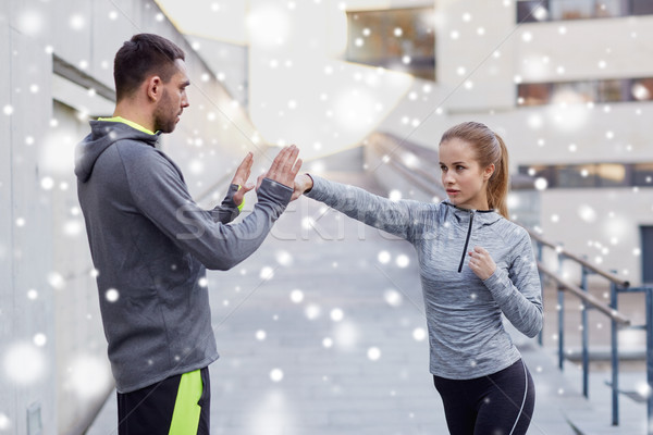 woman with coach working out strike outdoors Stock photo © dolgachov