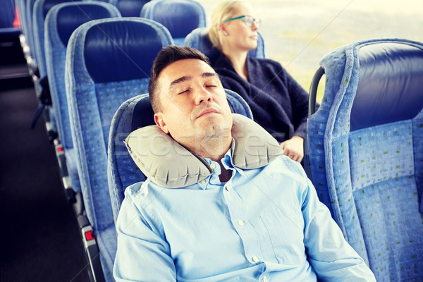 man sleeping in travel bus with cervical pillow Stock photo © dolgachov