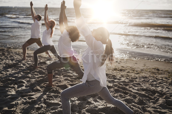 Grup de oameni yoga plajă fitness sportiv Imagine de stoc © dolgachov
