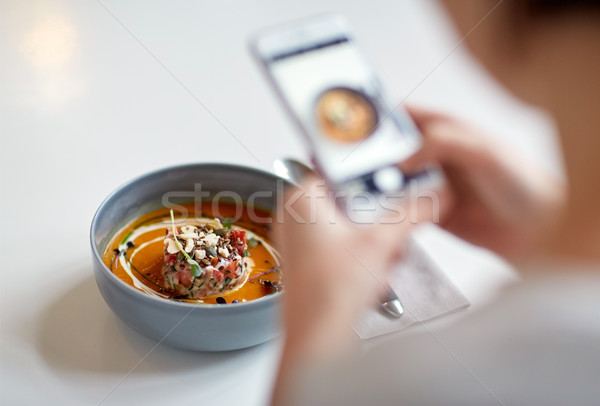 woman with smartphone photographing food at cafe Stock photo © dolgachov