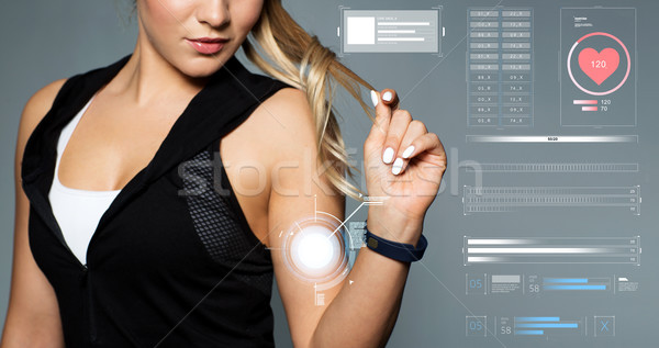 close up of sporty woman with fitness tracker Stock photo © dolgachov