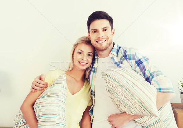 happy couple with stuff moving to new home Stock photo © dolgachov