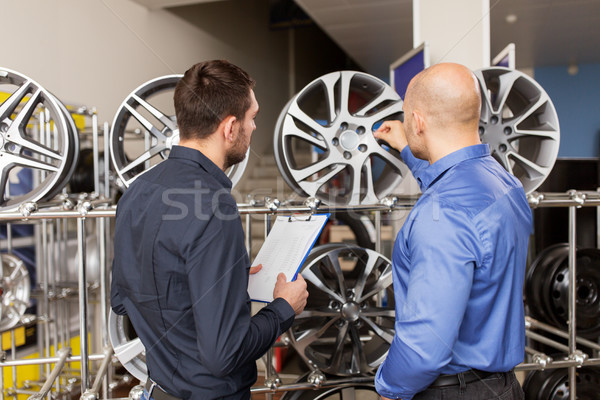 customer and salesman at car service or auto store Stock photo © dolgachov