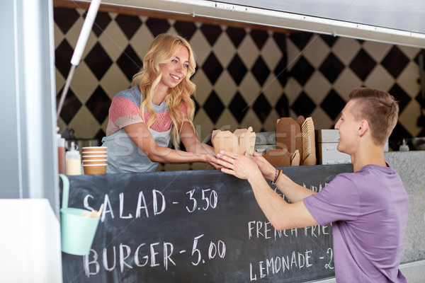 saleswoman at food truck serving male customer Stock photo © dolgachov